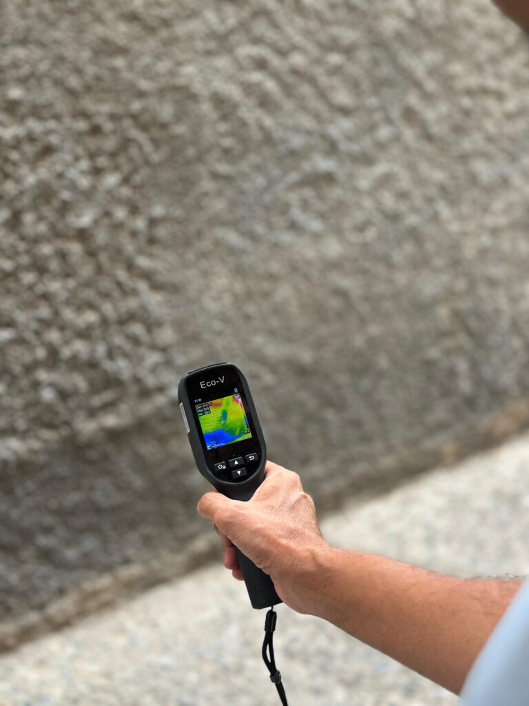 Thermal camera inspecting dampness on an exterior wall